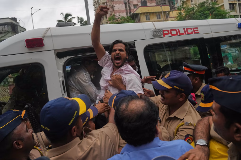 Police detain a supporter of the Cockroach Janta party during a protest in Mumbai.